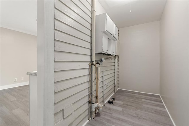 laundry area with light hardwood / wood-style floors