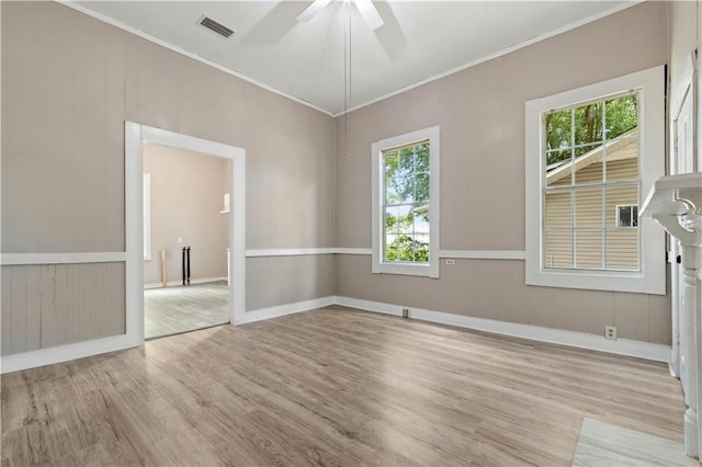 unfurnished room with ceiling fan, ornamental molding, and light wood-type flooring