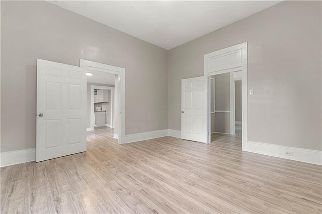 spare room featuring light wood-type flooring