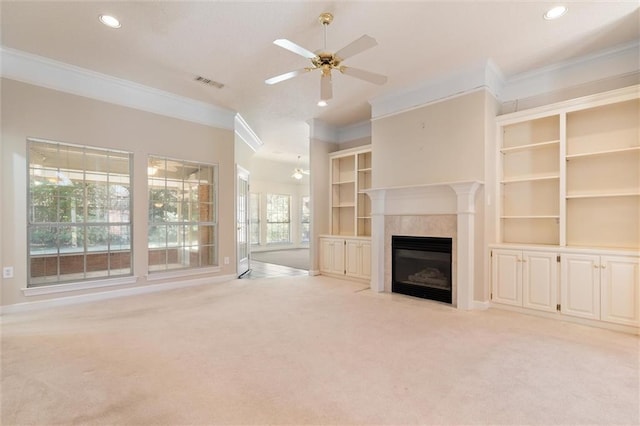 unfurnished living room with light carpet, a fireplace with flush hearth, visible vents, and crown molding