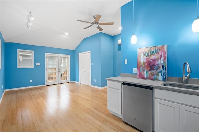 kitchen featuring hanging light fixtures, sink, ceiling fan, white cabinetry, and light hardwood / wood-style flooring