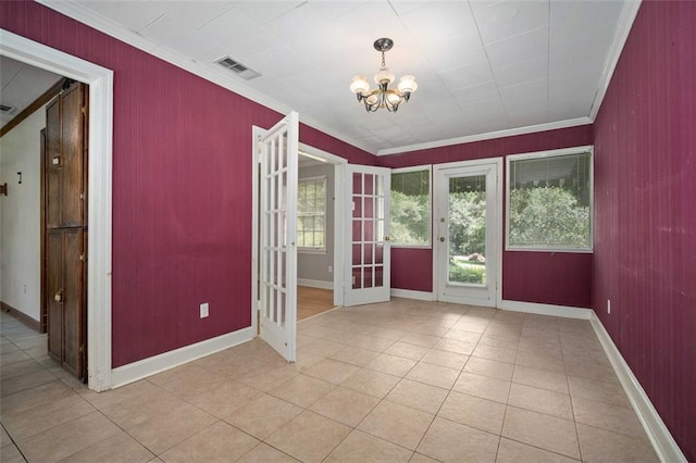 5405 Dogwood Ct, Mobile, AL 36693 - unfurnished room with french doors, a chandelier, crown molding, light tile patterned floors, and wood walls