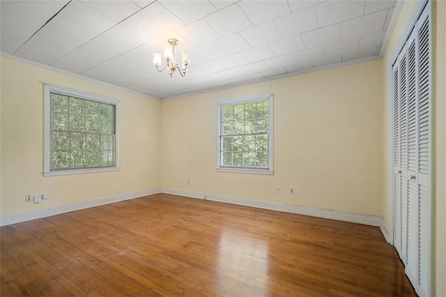 5405 Dogwood Ct, Mobile, AL 36693 - unfurnished bedroom with a chandelier, wood finished floors, ornamental molding, baseboards, and a closet