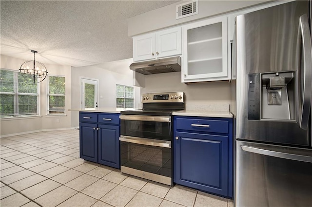 kitchen with light tile patterned flooring, light countertops, blue cabinetry, stainless steel appliances, and under cabinet range hood