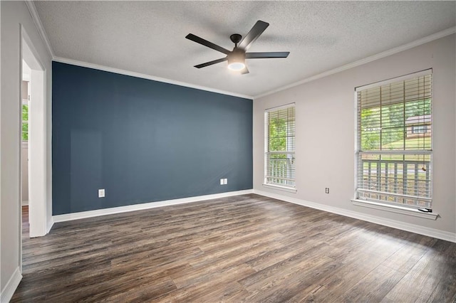 empty room featuring a textured ceiling, dark wood finished floors, ceiling fan, and a wealth of natural light