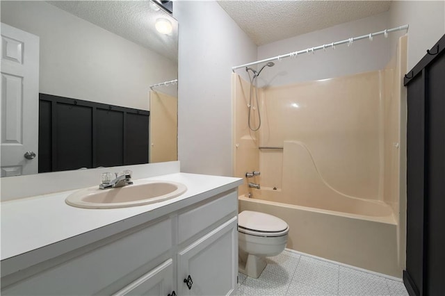 bathroom with vanity, toilet, bathtub / shower combination, a textured ceiling, and tile patterned floors