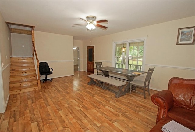 dining space with ceiling fan and light wood-type flooring