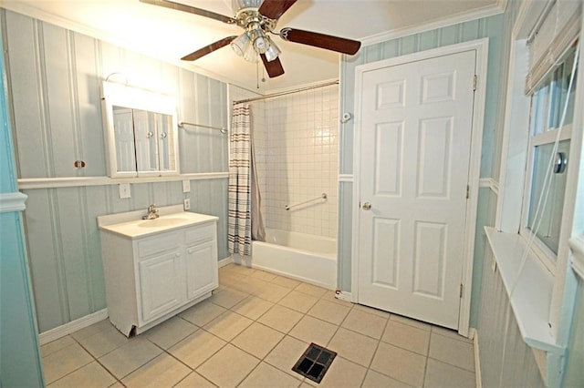 bathroom featuring vanity, tile patterned flooring, ceiling fan, shower / tub combo with curtain, and ornamental molding