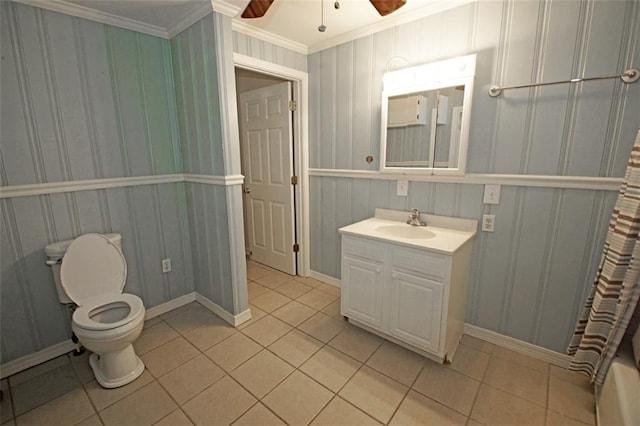 bathroom with vanity, crown molding, ceiling fan, toilet, and tile patterned floors