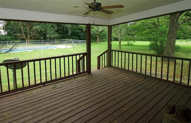 wooden deck with a lawn, ceiling fan, and pool water feature