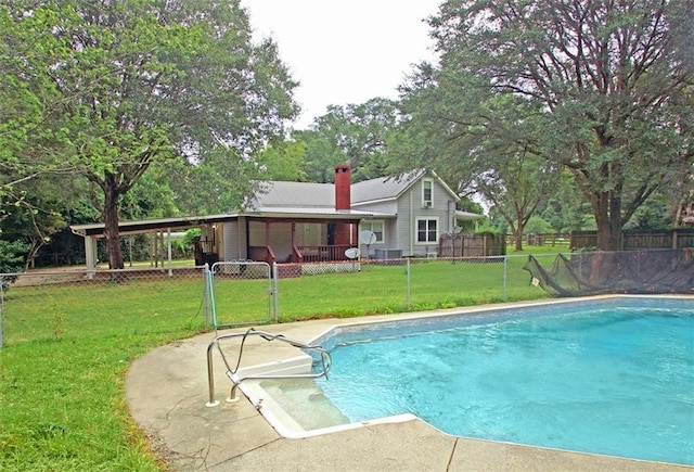 view of pool featuring a lawn