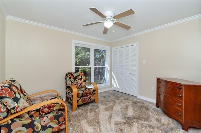 sitting room featuring light carpet, ornamental molding, and ceiling fan