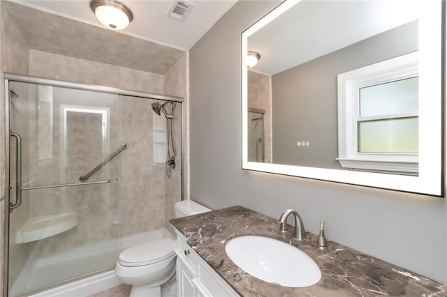 bathroom featuring vanity, toilet, and walk in shower