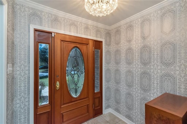 tiled entrance foyer with a healthy amount of sunlight, a notable chandelier, and ornamental molding