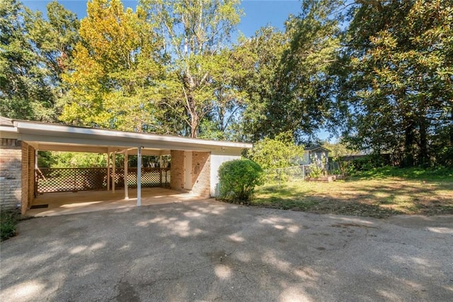 view of parking / parking lot featuring a carport