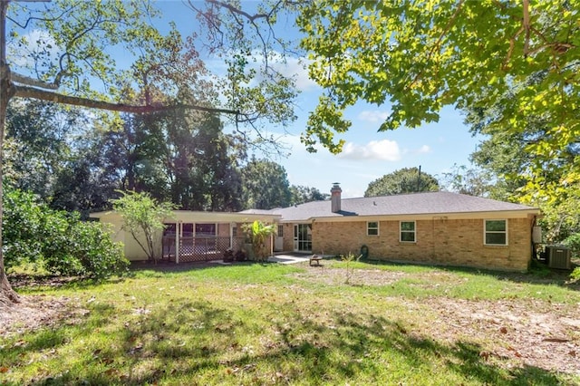 back of property with a yard and cooling unit