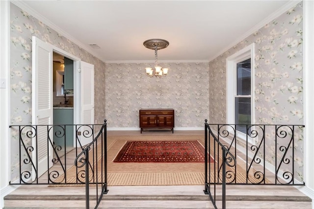 interior space featuring crown molding, a notable chandelier, and hardwood / wood-style flooring