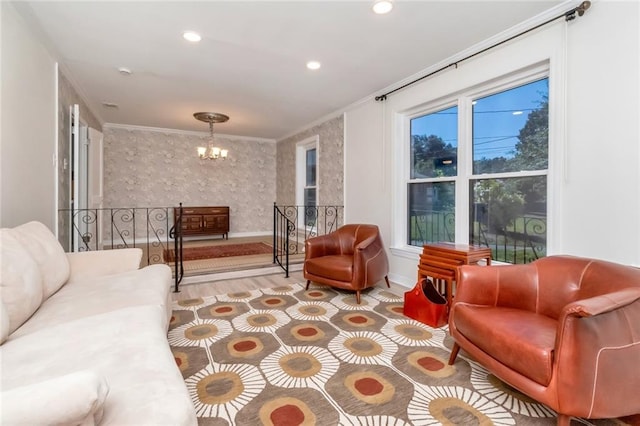 living room featuring light hardwood / wood-style flooring, crown molding, and an inviting chandelier