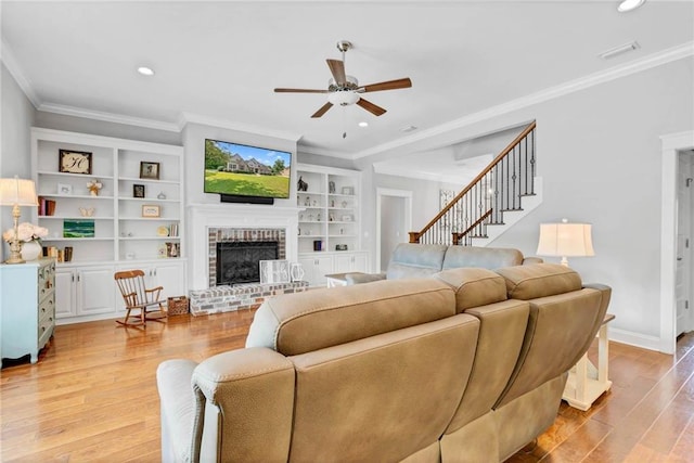 8662 Daintree Ct, Daphne, AL 36526 - living room with a ceiling fan, light wood-style floors, ornamental molding, a fireplace, and recessed lighting