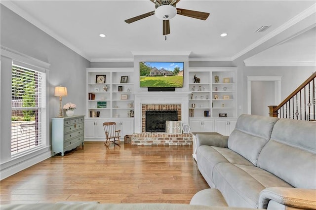 8662 Daintree Ct, Daphne, AL 36526 - living room featuring ornamental molding, light wood-type flooring, ceiling fan, a fireplace, and recessed lighting