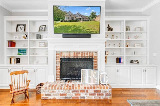 8662 Daintree Ct, Daphne, AL 36526 - living room with wood finished floors, crown molding, a fireplace, and built in features