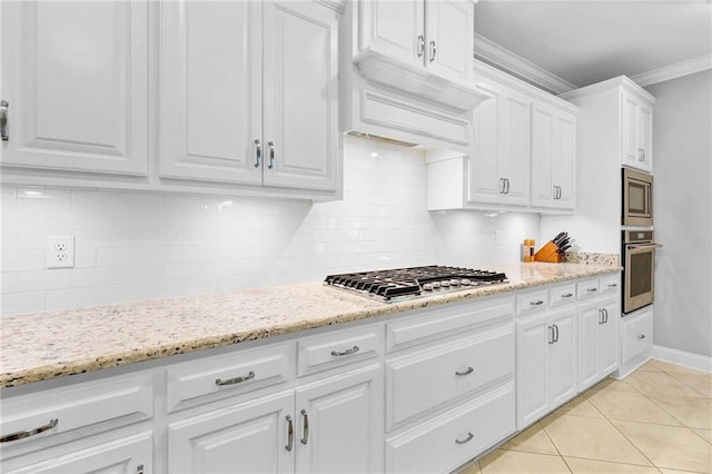 8662 Daintree Ct, Daphne, AL 36526 - kitchen featuring appliances with stainless steel finishes, crown molding, white cabinetry, light tile patterned flooring, and backsplash