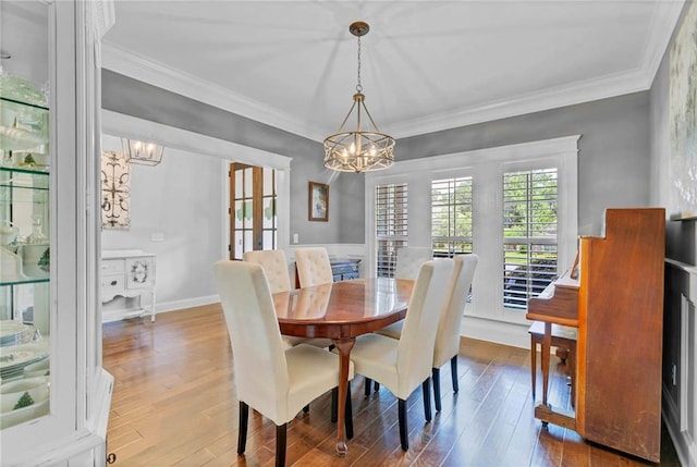 8662 Daintree Ct, Daphne, AL 36526 - dining space featuring a chandelier, wood finished floors, and ornamental molding