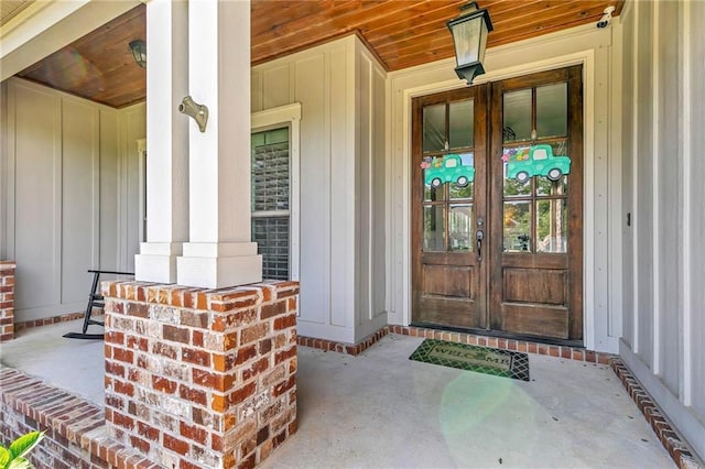 8662 Daintree Ct, Daphne, AL 36526 - doorway to property with french doors, board and batten siding, and a porch