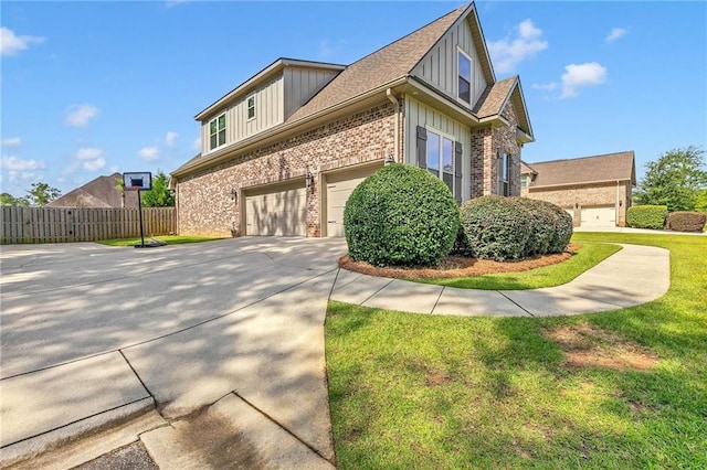 8662 Daintree Ct, Daphne, AL 36526 - view of side of property featuring board and batten siding, driveway, brick siding, and a garage