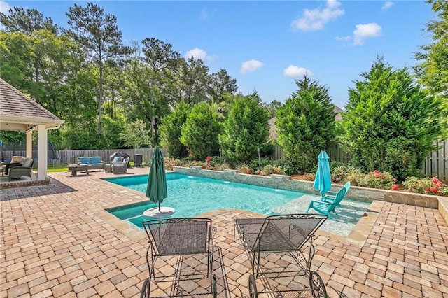 8662 Daintree Ct, Daphne, AL 36526 - view of swimming pool with an outdoor living space, a fenced backyard, a patio area, and view of wooded area