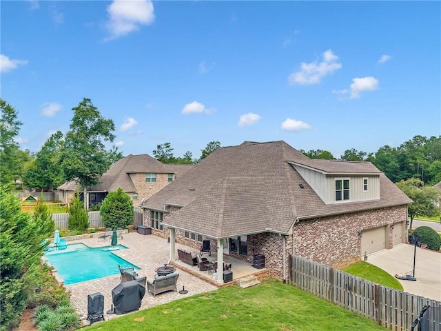 8662 Daintree Ct, Daphne, AL 36526 - rear view of house with a fenced backyard, driveway, outdoor lounge area, brick siding, and a patio