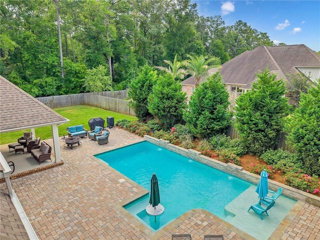 8662 Daintree Ct, Daphne, AL 36526 - view of pool featuring an outdoor living space with a fire pit, a patio, and a fenced backyard