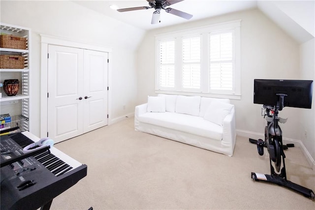 exercise room with baseboards, lofted ceiling, ceiling fan, and carpet floors