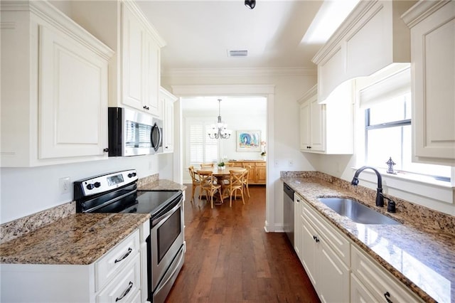 kitchen featuring a sink, a notable chandelier, white cabinetry, visible vents, and appliances with stainless steel finishes