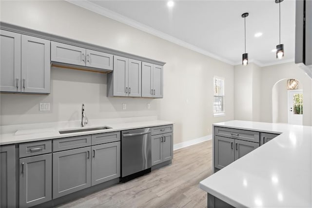 kitchen featuring dishwasher, a sink, and gray cabinetry