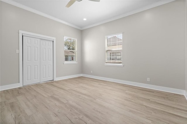 unfurnished bedroom featuring light wood-type flooring, baseboards, and ornamental molding