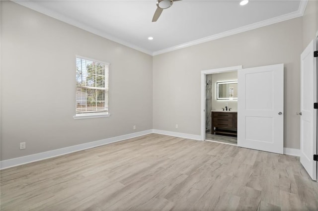 unfurnished bedroom with connected bathroom, baseboards, light wood finished floors, and ornamental molding