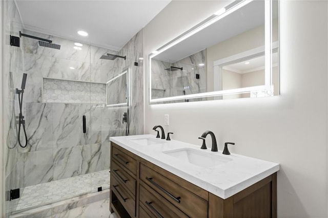 bathroom with a sink, a marble finish shower, marble finish floor, and double vanity