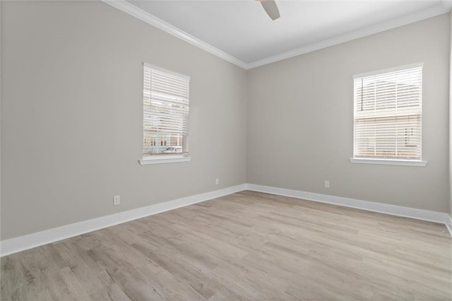 empty room featuring baseboards, plenty of natural light, crown molding, and light wood finished floors