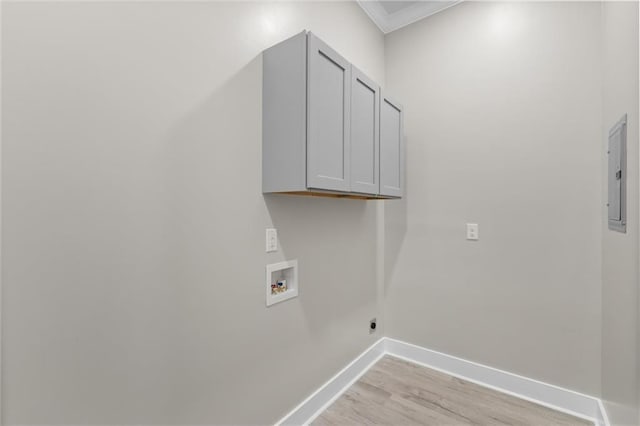 laundry area with ornamental molding, cabinet space, light wood finished floors, baseboards, and hookup for a washing machine