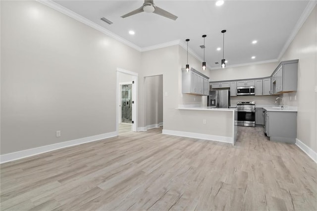 kitchen with visible vents, gray cabinets, a sink, open floor plan, and stainless steel appliances