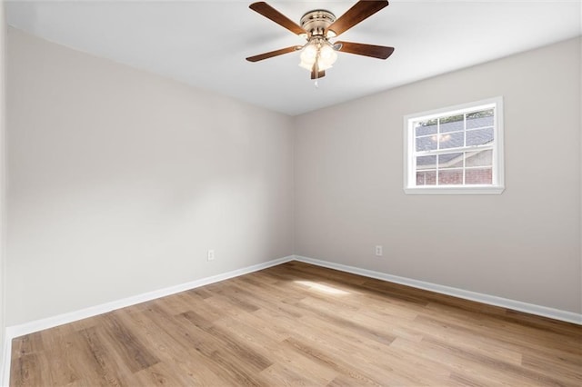 unfurnished room featuring a ceiling fan, light wood-style flooring, and baseboards