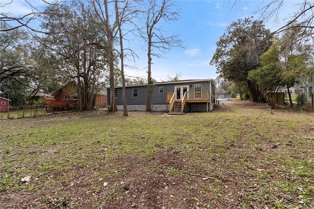 back of house with a yard, a deck, and fence