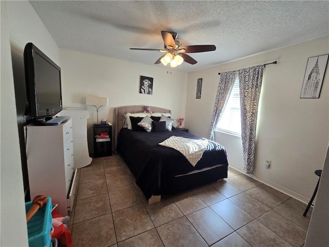 tiled bedroom featuring a textured ceiling and ceiling fan