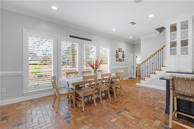 dining area featuring crown molding