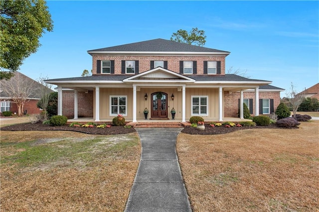 view of front of house with a porch and a front yard