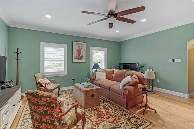 living room with crown molding, ceiling fan, and light wood-type flooring