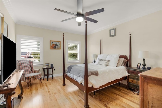 bedroom with ornamental molding, ceiling fan, and light hardwood / wood-style flooring