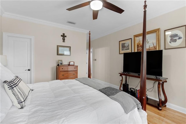 bedroom featuring ceiling fan, ornamental molding, and light hardwood / wood-style flooring