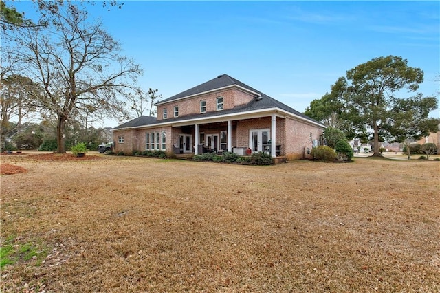 back of property with a lawn